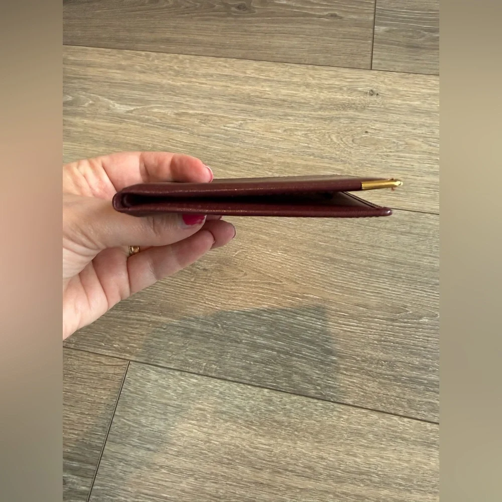 Cartier Men’s Deep Red Leather Bifold with Gold Corners